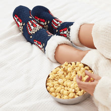 Load image into Gallery viewer, The Foozie™ Popcorn slipper socks, crossed feet on a white bed beside a bowl of popcorn
